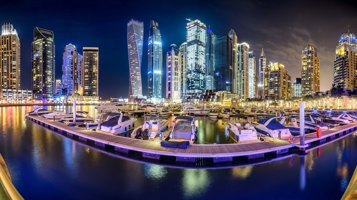 Dubai Marina cityscape at night with yachts