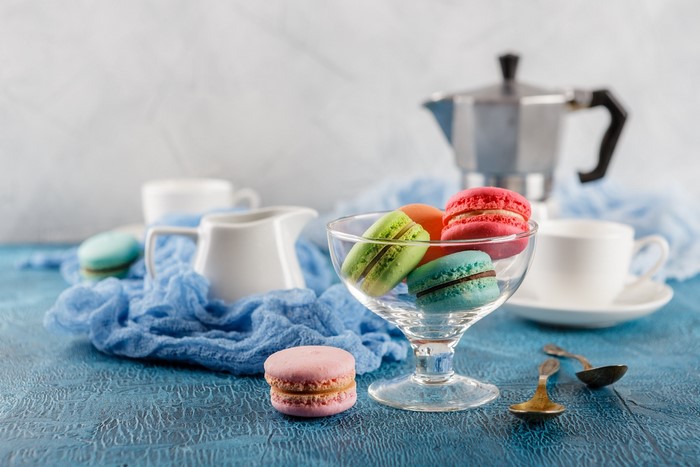 Still life of colorful macarons and coffee set