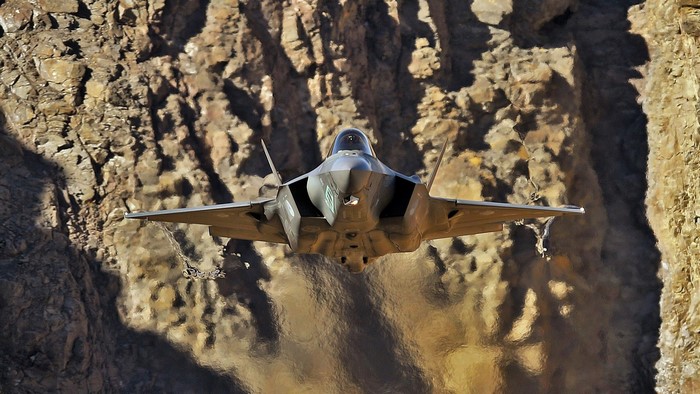 F-35 fighter jet flying through a canyon