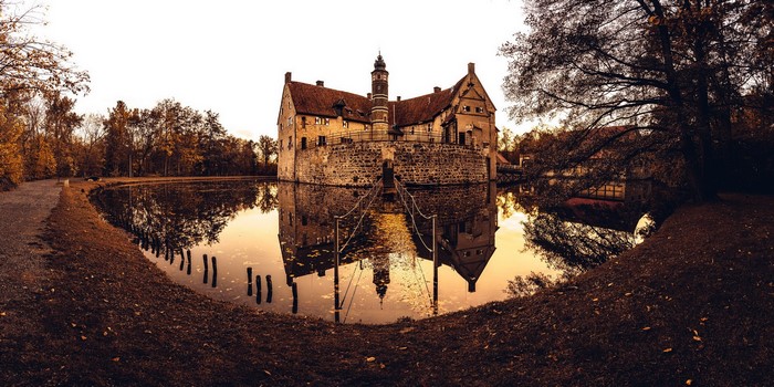 Castle surrounded by a moat in fall
