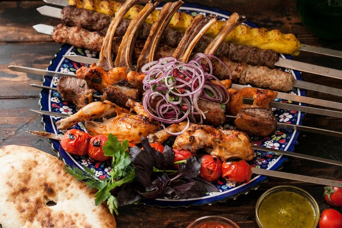 Assortment of grilled meats and vegetables on skewers