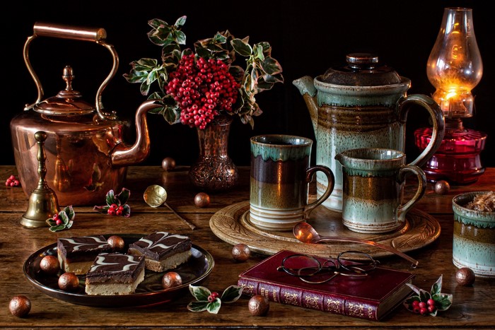 Still life with cakes, tea set, and oil lamp