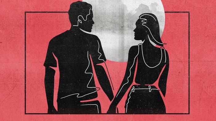 Couple holding hands in front of a moon