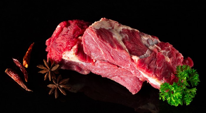 Raw beef with star anise, chili peppers, and parsley