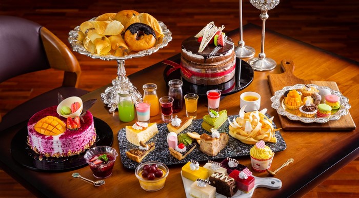 Assortment of cakes, donuts, and pastries on a table
