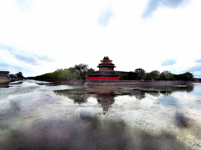 Corner tower of the Forbidden City reflected in the moat