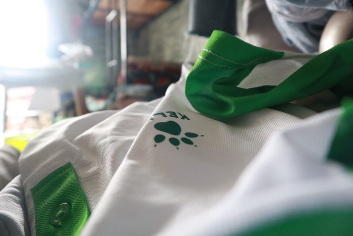 Kelme logo on white and green fabric