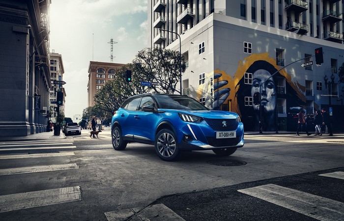Blue Peugeot 2008 SUV on city street with graffiti