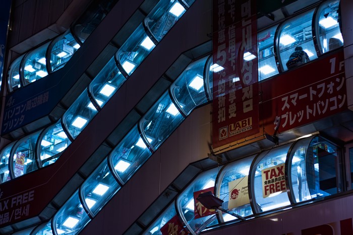 Escalators in a Japanese electronics store at night