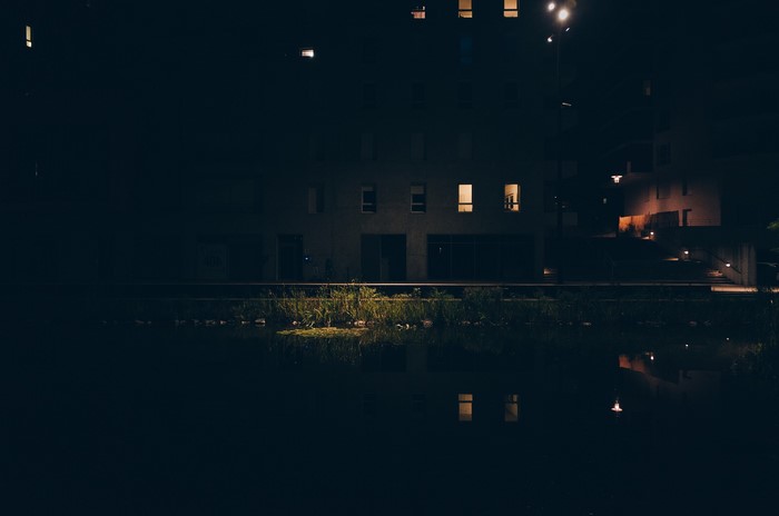 Building at night with water reflection