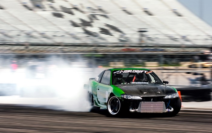 Green Nissan Silvia S13 drifting with smoke