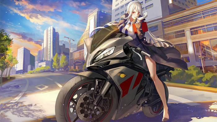Girl with blonde hair on a motorcycle in a city
