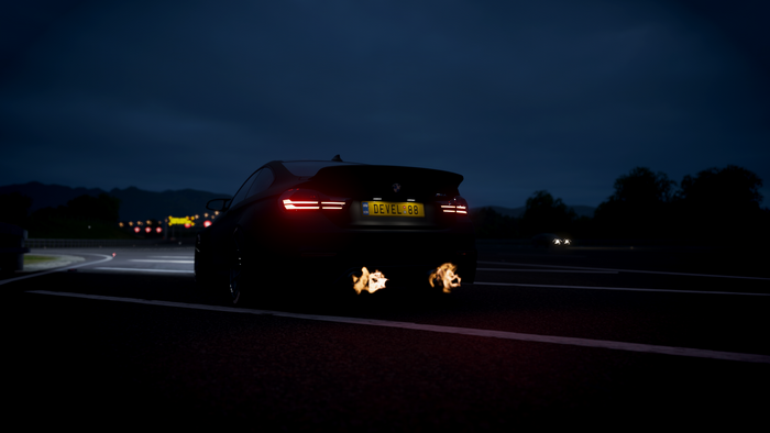 BMW M4 with flames coming out of exhaust at night