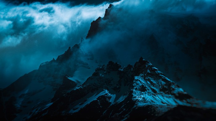 Dark, misty, snowy mountain peaks