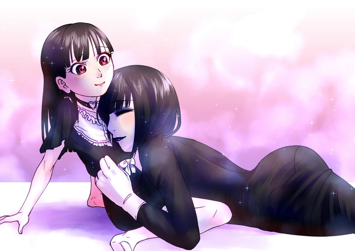 Two girls in black outfits cuddling