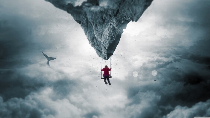 Child on a swing under a floating island with a whale tail