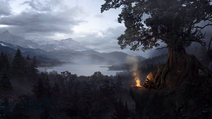 Man sitting by campfire near lake and mountains
