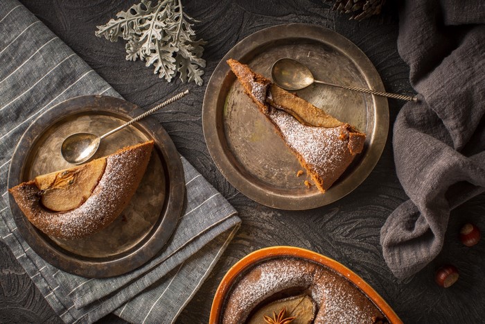 Still life with apple cake slices and spoons