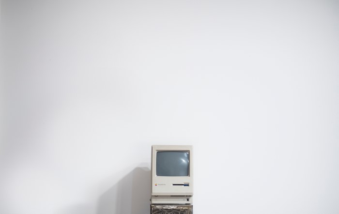 Retro Apple Macintosh computer on a stand