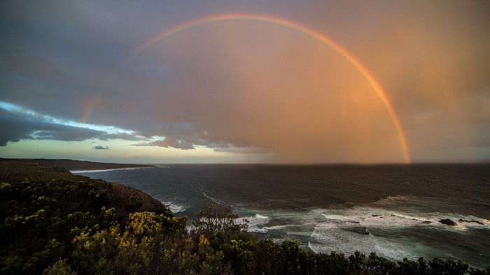 Double rainbow over the ocean and coastline
