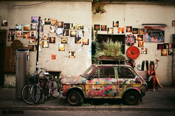 Kraków, Poland: A psychedelic car and photos on a wall