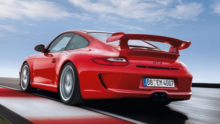 Red Porsche 911 GT3 on a race track