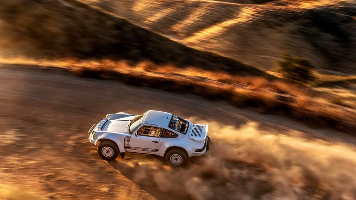 White Porsche 911 rally car driving offroad