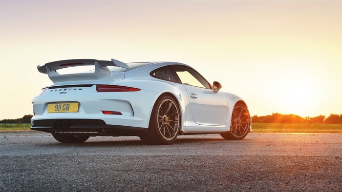 White Porsche 911 GT3 on a road at sunset
