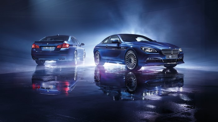 Two blue Alpina BMW cars on a wet surface
