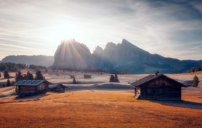 Wooden cabins in a mountain landscape at sunrise