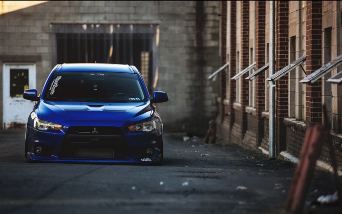 Blue Mitsubishi Lancer Evolution parked in an alley