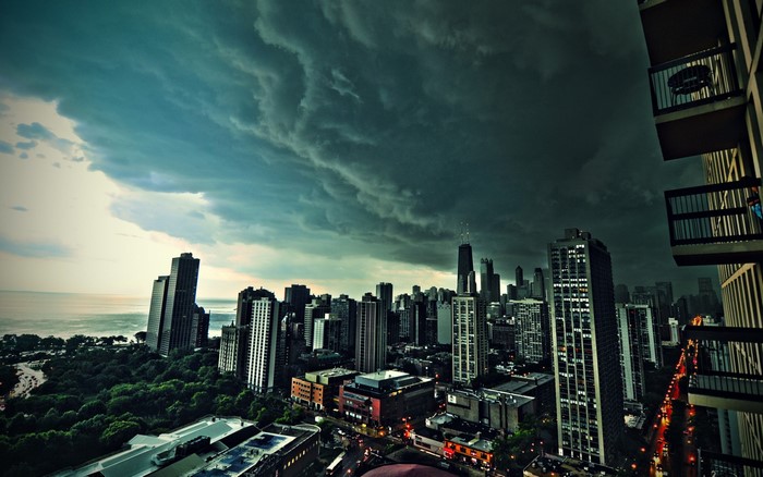 Stormy sky over Chicago skyline with lake and trees