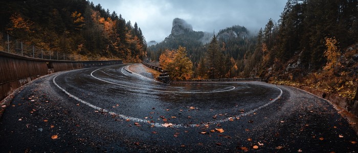 Winding mountain road in fall with fog