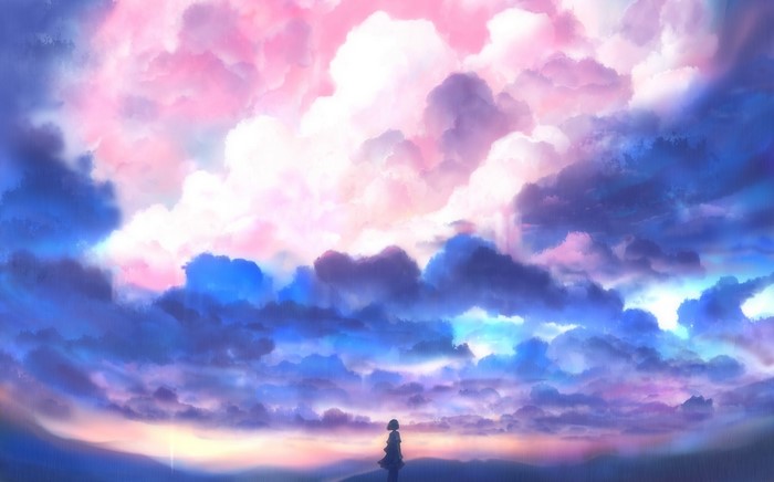 Girl standing in front of colorful clouds