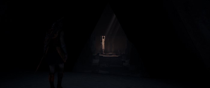 Character from Assassin's Creed in a dark chamber