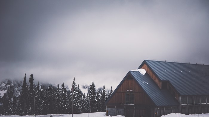 Cabin in a Snowy Forest Landscape