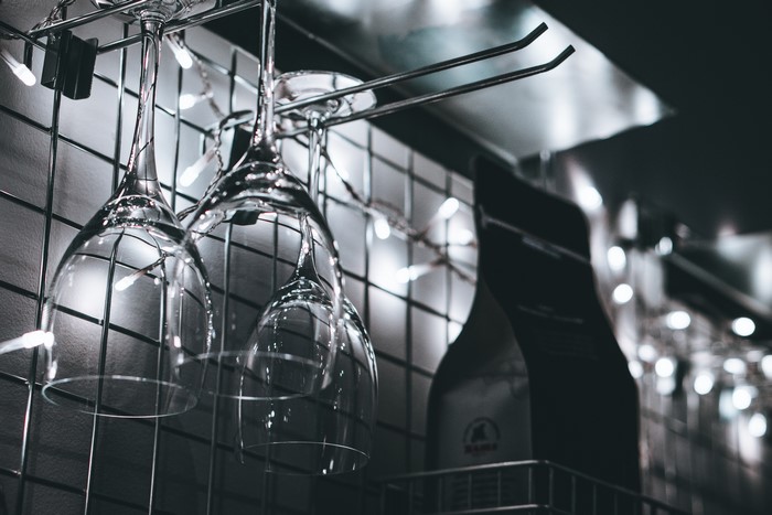 Wine glasses hanging with string lights