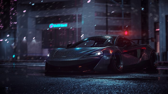 McLaren supercar on a wet city street at night