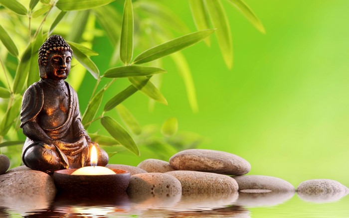 Buddha Statue with Candle and Stones