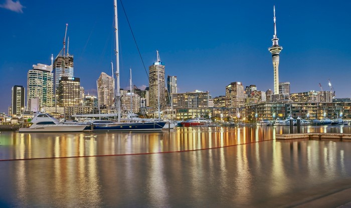 Auckland cityscape with harbor and yachts at dusk