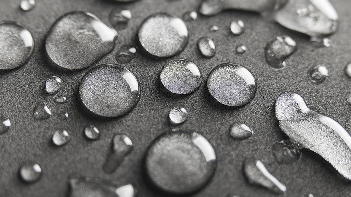 Macro view of water drops on gray surface