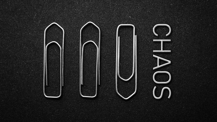 Paperclips and the word CHAOS on a dark background