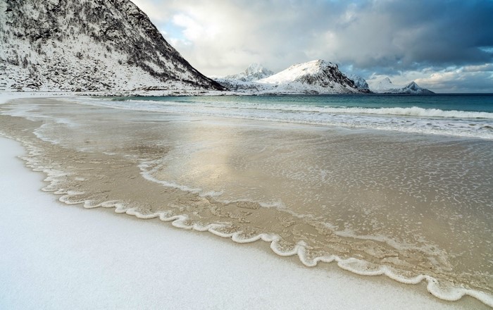 Snowy beach and mountains in Lofoten, Norway