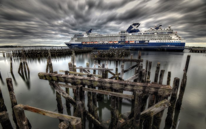 Celebrity Cruises ship docked near old pier pilings