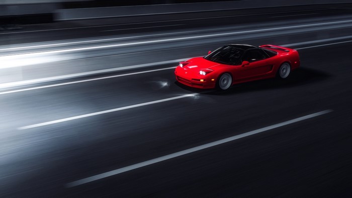 Red Honda NSX Mk1 driving on a highway at night