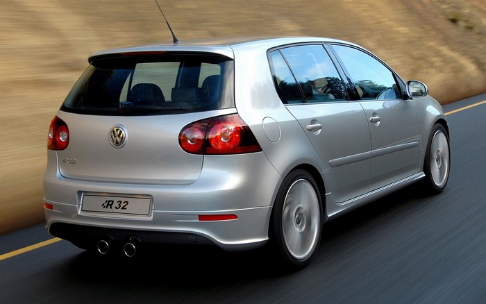 Silver Volkswagen Golf R32 driving on a road