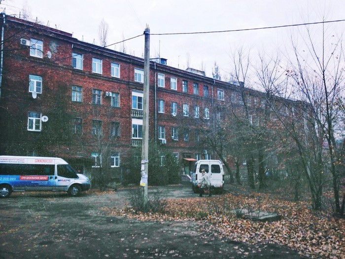 Brick apartment building with vans in Russia