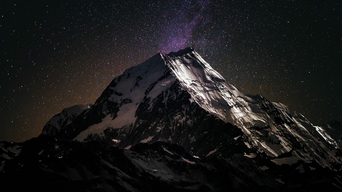 Mountain peak under a starry sky