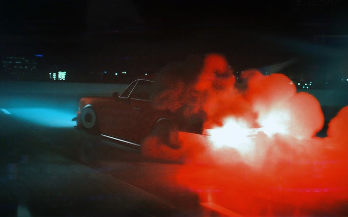 Red car with smoke at night
