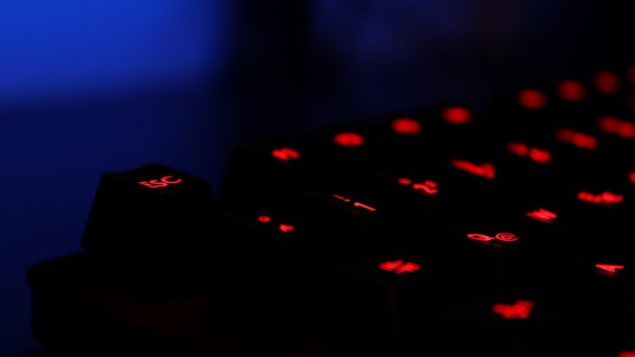 Close-up of a backlit keyboard with red lighting